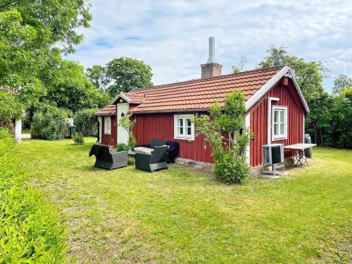 a red house with couches in front of it at 4 person holiday home in FÄRJESTADEN-By Traum in Färjestaden