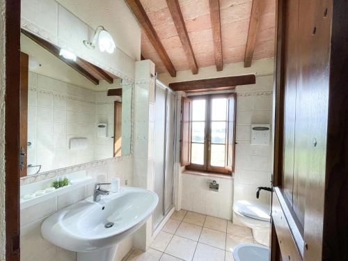 a bathroom with a sink and a toilet and a mirror at La Valle delle Favole in Ponte Pattoli