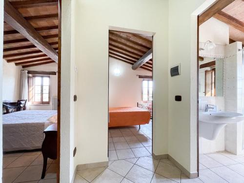 a bathroom with a bed and a sink in a room at La Valle delle Favole in Ponte Pattoli