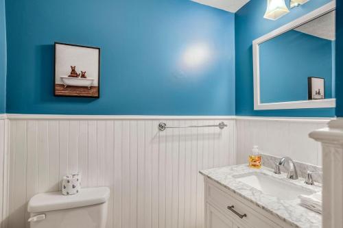 a blue bathroom with a toilet and a sink at Alpine Sanctuary in Valle Crucis