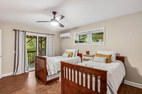 a bedroom with two beds and a ceiling fan at Alpine Sanctuary in Valle Crucis