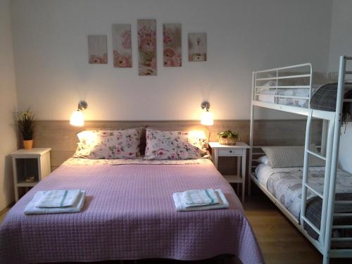 a bedroom with a bed and a bunk bed at La Casa delle Betulle in Cardano al Campo