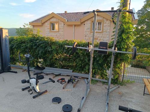 a home gym with equipment in front of a house at Apartman Glorija in Kotor