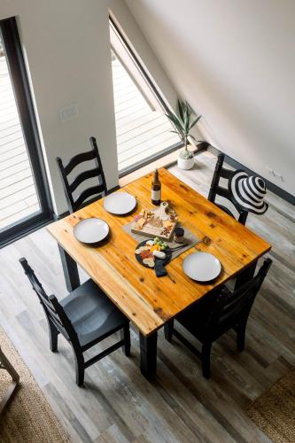 a wooden table and chairs in a room at A Frame of Mind in Dahlonega