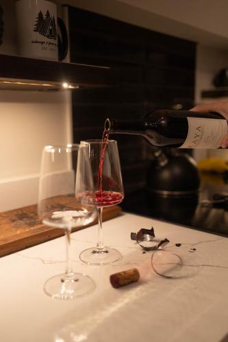 a bottle of wine being poured into a wine glass at A Frame of Mind in Dahlonega