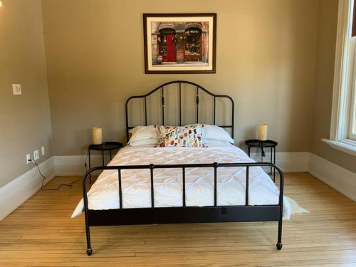 a bedroom with a bed with two night stands at Modern Vintage Vibe Condo in Milwaukee