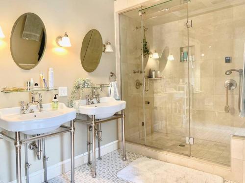 a bathroom with two sinks and a shower at Modern Vintage Vibe Condo in Milwaukee