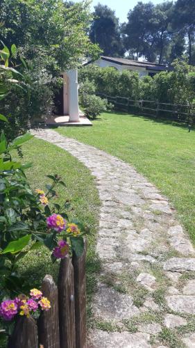 a garden with a fence and some flowers at Villa Biancospini - guesthouse Le Case di Aurelia in Castellaneta Marina