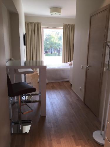 a room with a table and a bed in the background at Pärnu Apartment in Pärnu