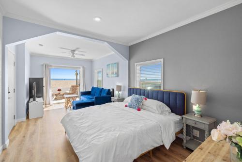 a bedroom with a bed and a blue chair at 1628 West Oceanfront Oasis 1 in Newport Beach