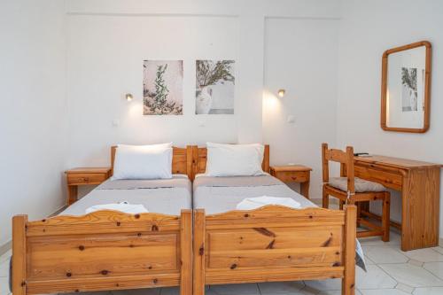 a bedroom with two beds and a desk at Fiore Di Mare Studios in Lassi