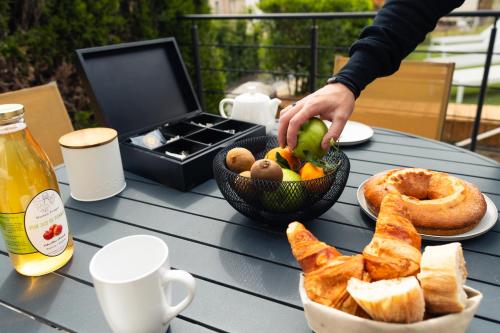 a table with a bowl of food and a basket of bread at Gîte petite lauze in Espalion