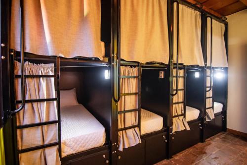 a group of four bunk beds in a room at Yes Please! Hostel in Antigua Guatemala