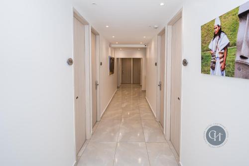 a hallway with white walls and a painting on the wall at Hotel Chayrama in Santa Marta