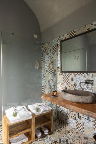 a bathroom with a sink and a mirror on the wall at Masseria San Francesco in Savelletri di Fasano