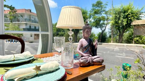 a statue sitting on a table with a lamp at Hotel El Curro in Burunchel