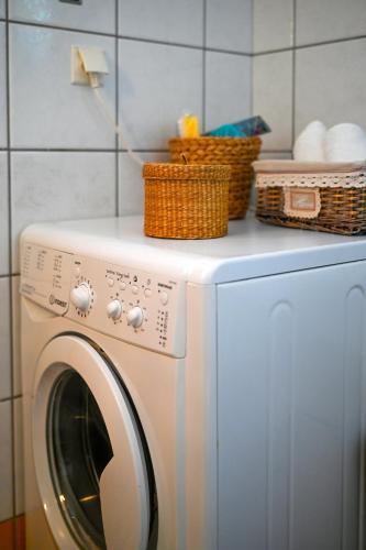 a washing machine with baskets on top of it at "Kochili Villa" LUXURY VILLA in Áyios Andréas