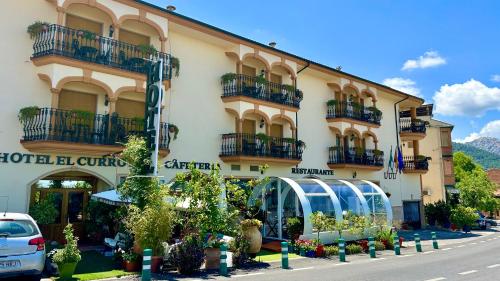 a building with a glass greenhouse in front of it at Hotel El Curro in Burunchel