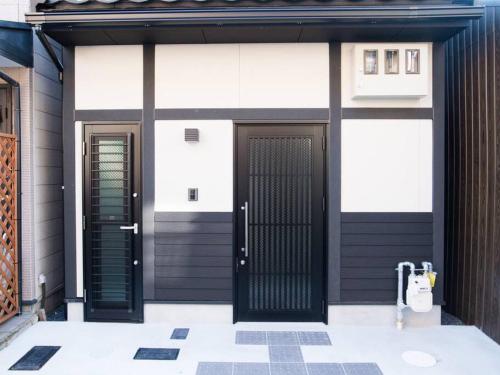 a building with two doors on the side of it at Miyanonoki Toji Kyoto in Kyoto