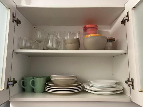 a cabinet filled with plates and bowls and glasses at Casa Armonía Paz y confort ideal para familias buscando naturaleza in Bella Vista
