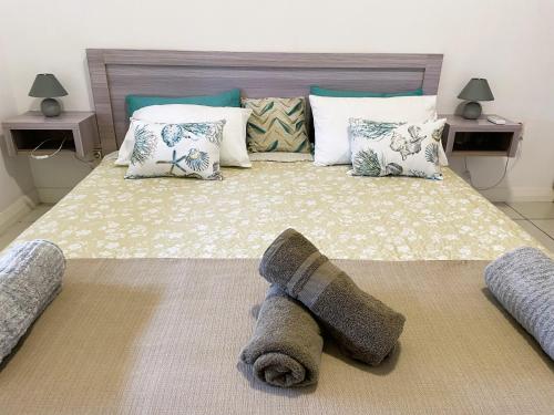 a bedroom with a large bed with pillows at SG5 l Le Turquoise - second line Beachfront in Cap Malheureux