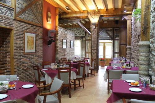 a dining room with purple tables and chairs at Hotel San Roque in Reinosa