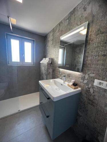a bathroom with a sink and a mirror at Vesuvius Pompeii in Pompei