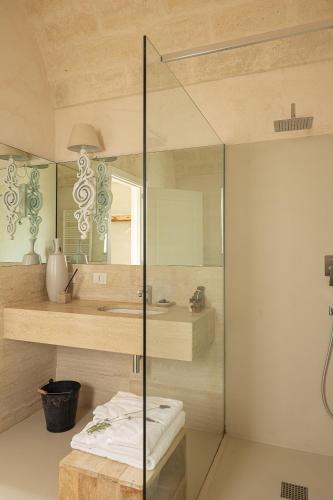 a bathroom with a glass shower and a sink at Masseria San Francesco in Savelletri di Fasano