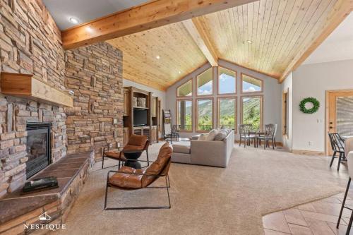 a living room with a stone wall and a fireplace at Private Weber Tributary Access Family Retreat in Morgan Hosted by Nestique in Morgan