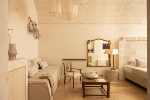 a living room with a couch and a mirror at Masseria San Francesco in Savelletri di Fasano