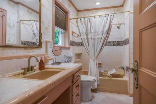 a bathroom with a sink and a toilet and a shower at The Magnolia House in Sparta