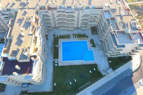 an aerial view of a building with a swimming pool at Pool and sea view accommodation 50 m sea in Furadouro