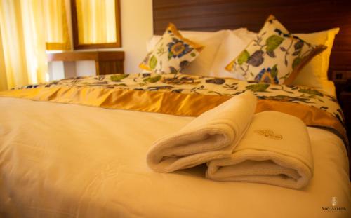 a bed with towels on top of it at Nirvana Bliss By Clove in Anuradhapura