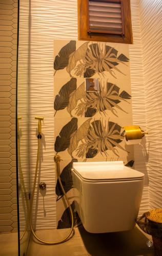 a bathroom with a toilet and a shower at Nirvana Bliss By Clove in Anuradhapura