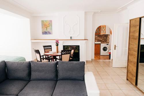 a living room with a couch and a table at Castle Village Apartment in Krásnohorské Podhradie