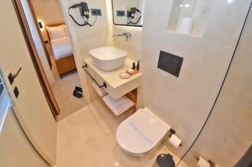 a small bathroom with a toilet and a sink at Ferhadija 31 Old town Sarajevo in Sarajevo