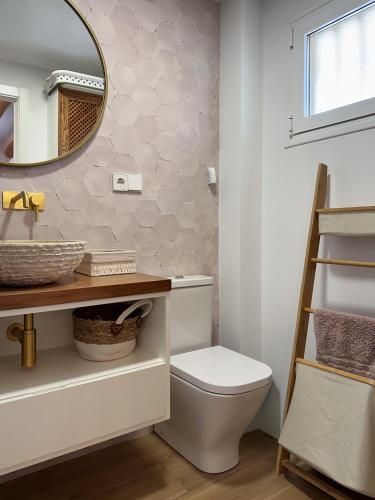 a bathroom with a toilet and a mirror at El Rinconet de Loreto in El Campello
