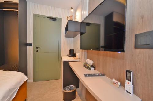 a bathroom with a sink and a mirror and a bed at Ferhadija 31 Old town Sarajevo in Sarajevo