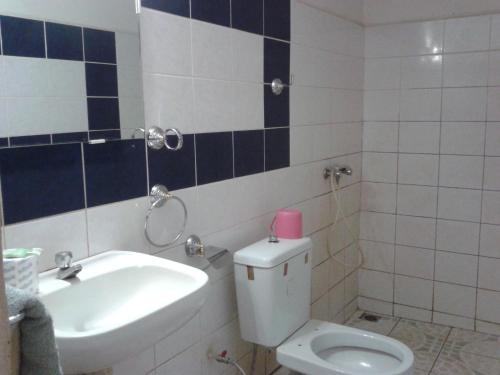 a bathroom with a toilet and a sink at Hotel Valiha in Diego Suarez