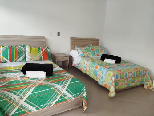 two beds sitting next to each other in a room at HOTEL GLASS LAS VEGAS in La Vega