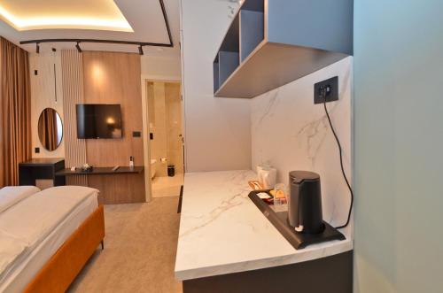 a hotel room with a bed and a television at Ferhadija 31 Old town Sarajevo in Sarajevo