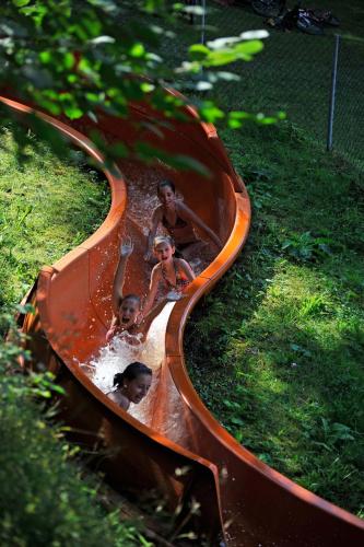 a group of children playing in a water slide at Ferienparadies Natterer See in Innsbruck