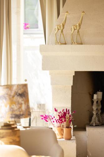 a living room with a fireplace with two giraffe figurines at Masseria San Francesco in Savelletri di Fasano