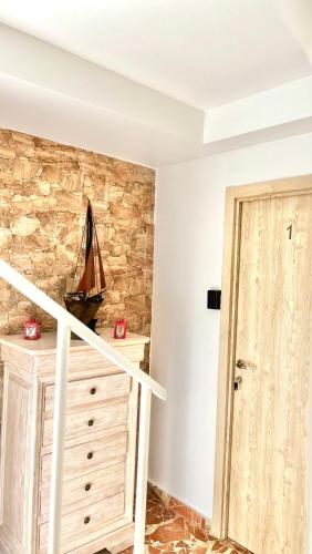 a room with a staircase and a stone wall at A Casa de Santos in Combarro