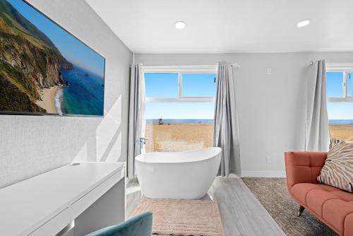 a bathroom with a tub and a chair and a window at 1628 West Oceanfront Oasis 8 in Newport Beach