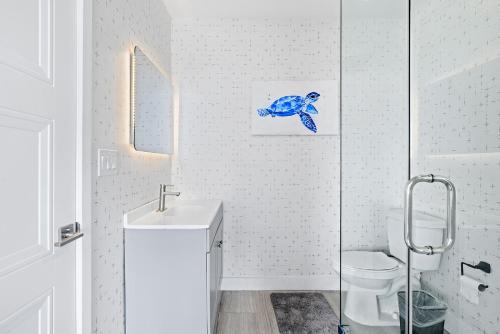 a white bathroom with a sink and a toilet at 1628 West Oceanfront Oasis 8 in Newport Beach