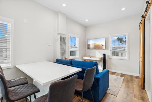 a living room with a couch and a table and chairs at 1628 West Oceanfront Oasis 5 in Newport Beach