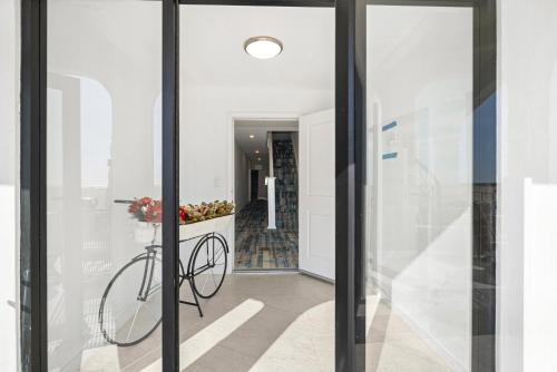 a bicycle is in the hallway of a house at 1628 West Oceanfront Oasis 5 in Newport Beach