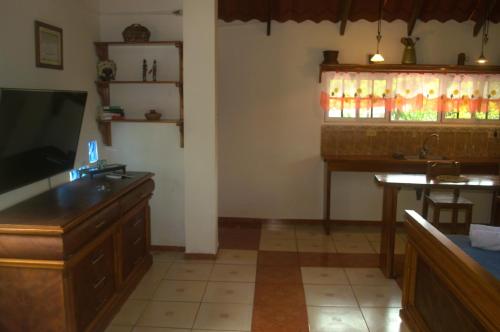 a living room with a television and a table and a sink at Darwin's temple 3 in San Cristobal