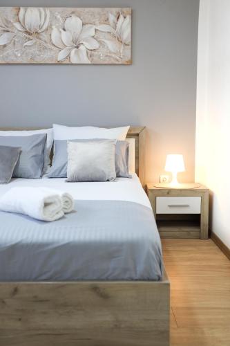 a bedroom with a bed with a white towel on it at Airport Stay Apartments in Surčin